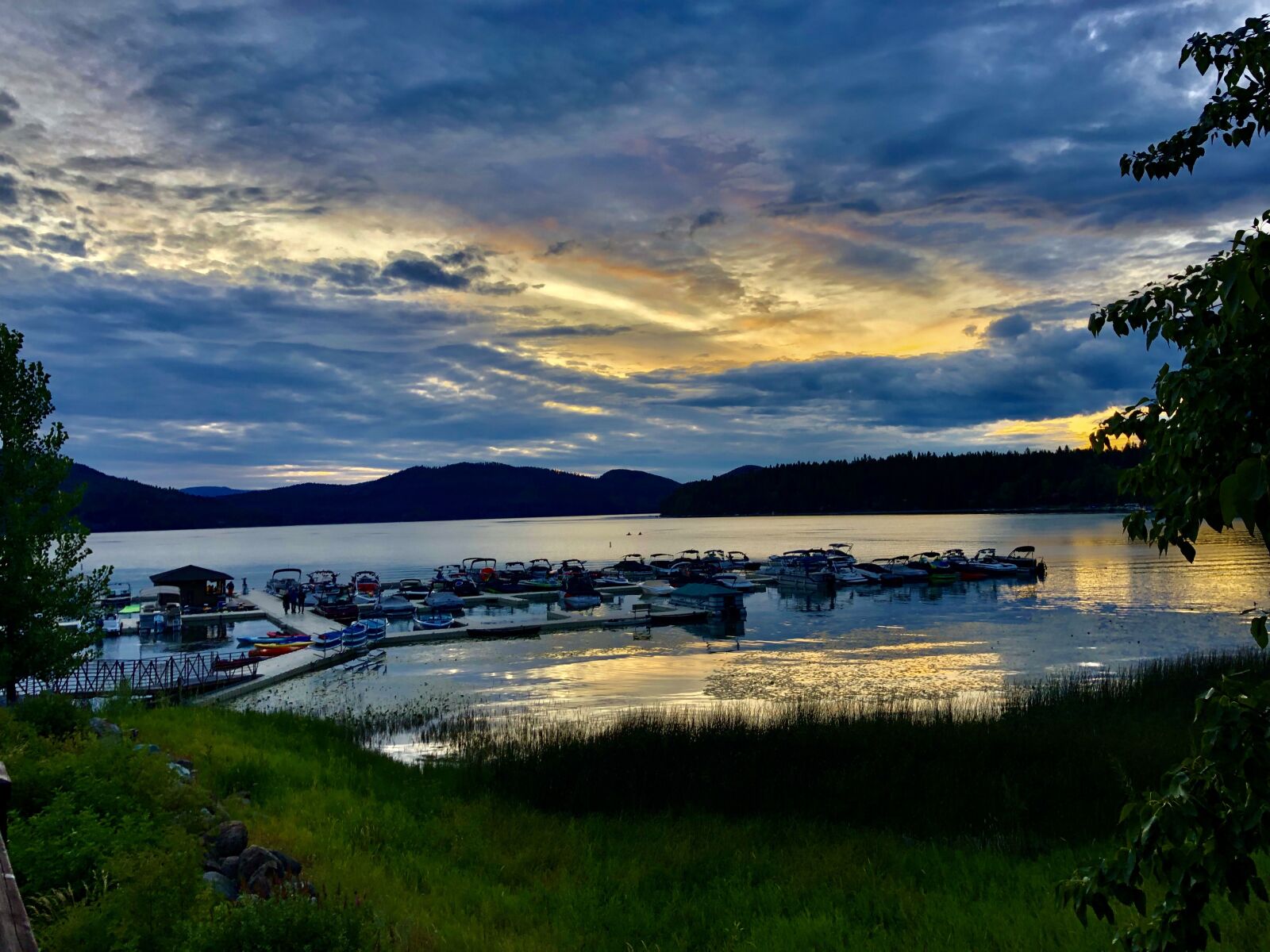 iPhone X back dual camera 4mm f/1.8 sample photo. Sunset, boats, lake photography