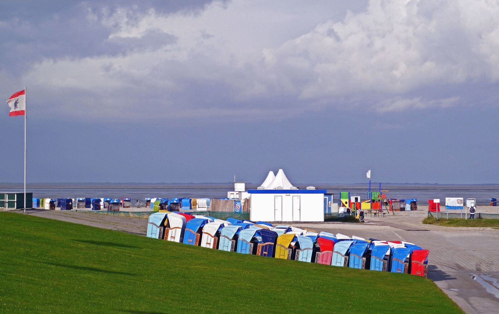 Panasonic Lumix DMC-GX1 sample photo. Sky, beach, sea, flag photography