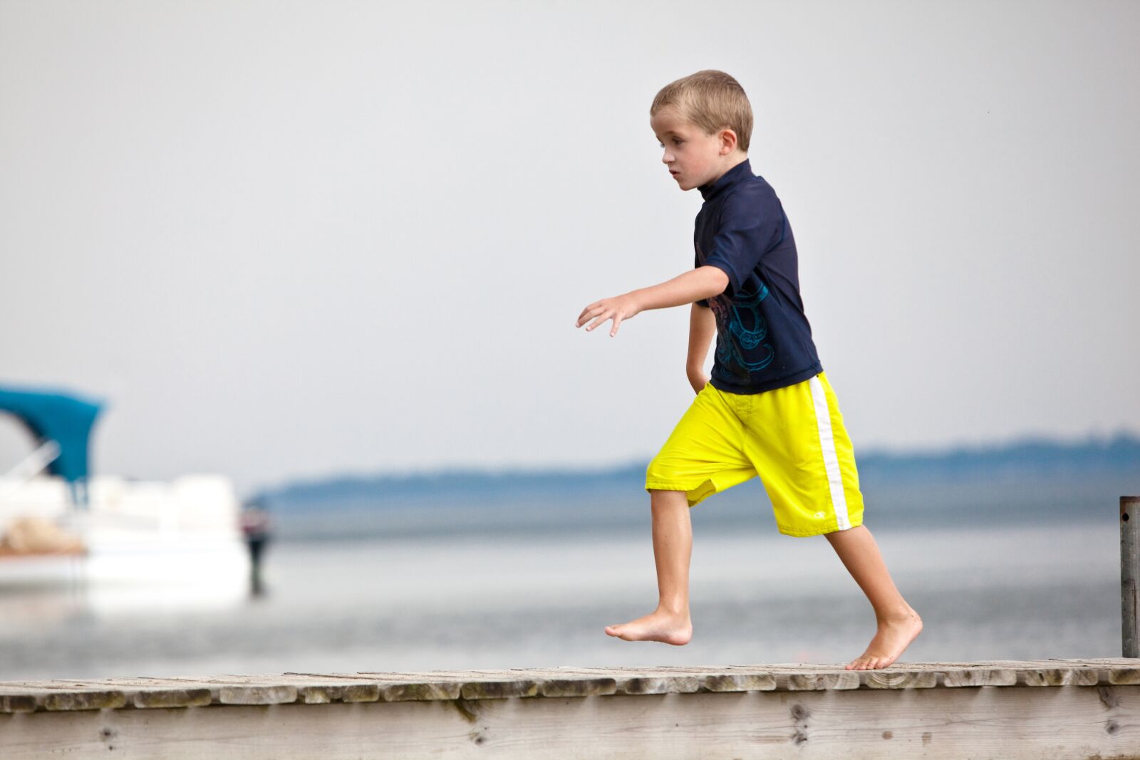 Canon EOS 5D Mark II sample photo. Dock, young boy, running photography