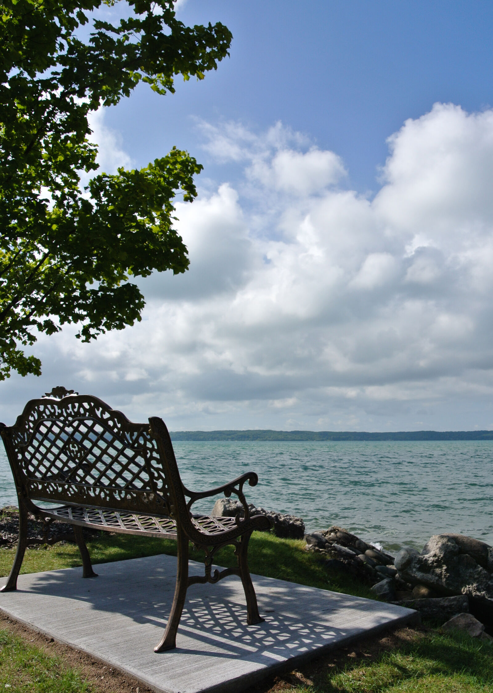 Nikon 1 Nikkor VR 10-30mm F3.5-5.6 sample photo. Bench, calm, clouds, lake photography