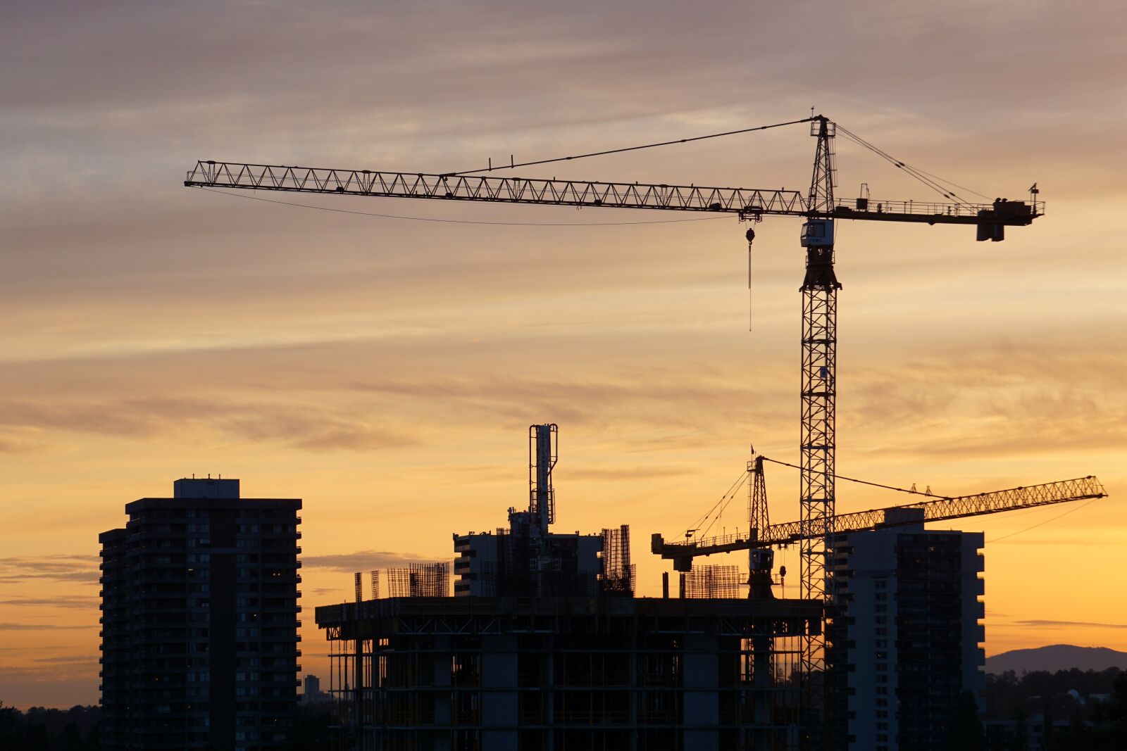 Sony E 55-210mm F4.5-6.3 OSS sample photo. Silhouette, buildings, sunset photography
