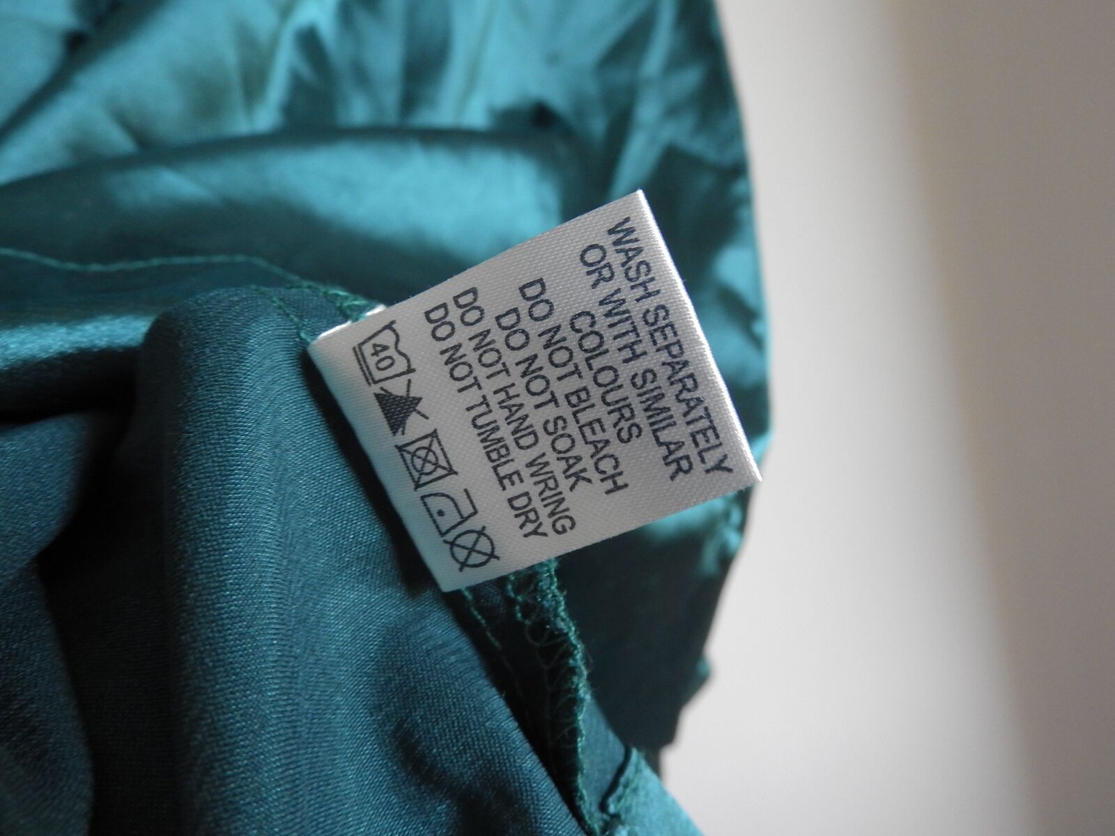 Nikon Coolpix P610 sample photo. Sign in clothes, clothing photography