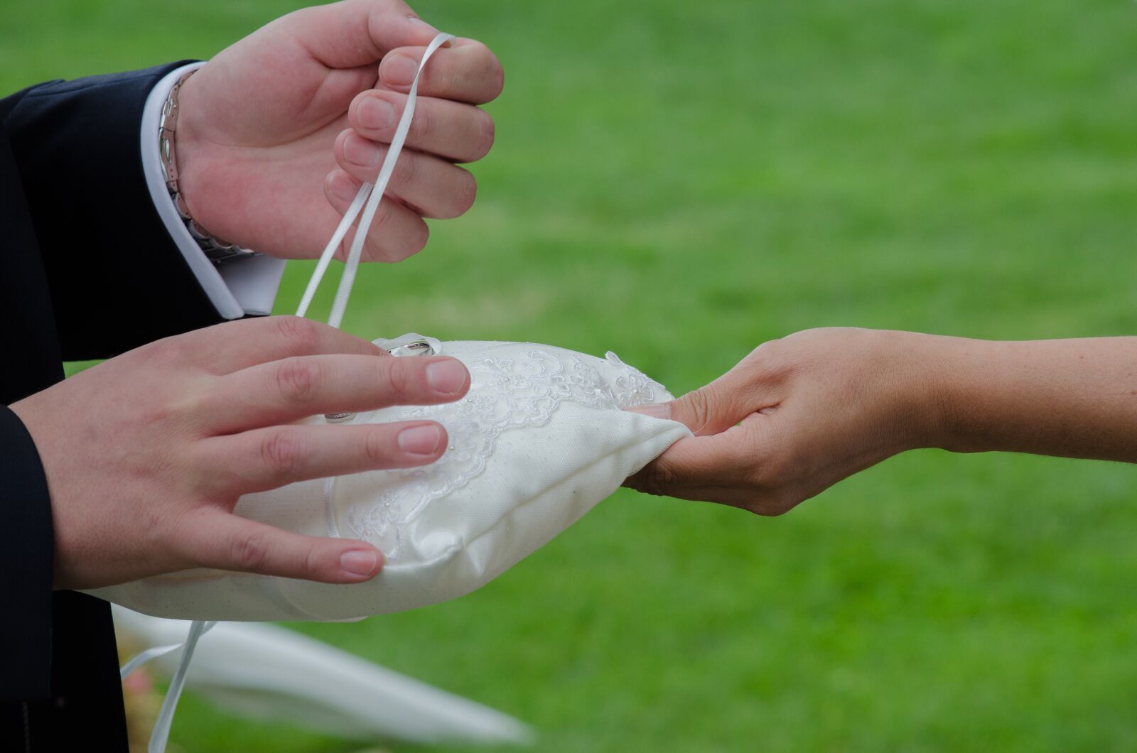 Nikon D5100 sample photo. Wedding, ring pillow, hands photography