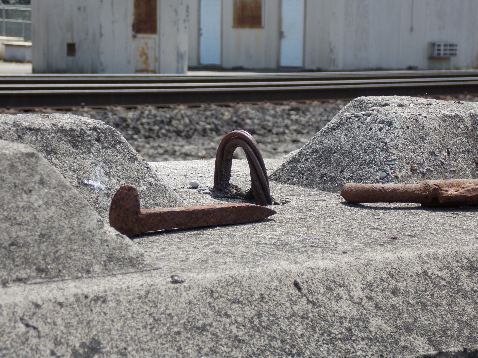 Nikon Coolpix L810 sample photo. Spike, railroad, concrete photography