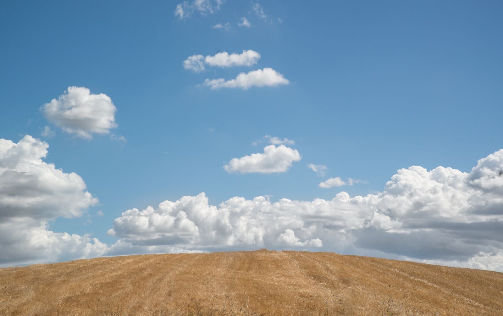 Nikon D610 sample photo. Hill, blue sky, clouds photography