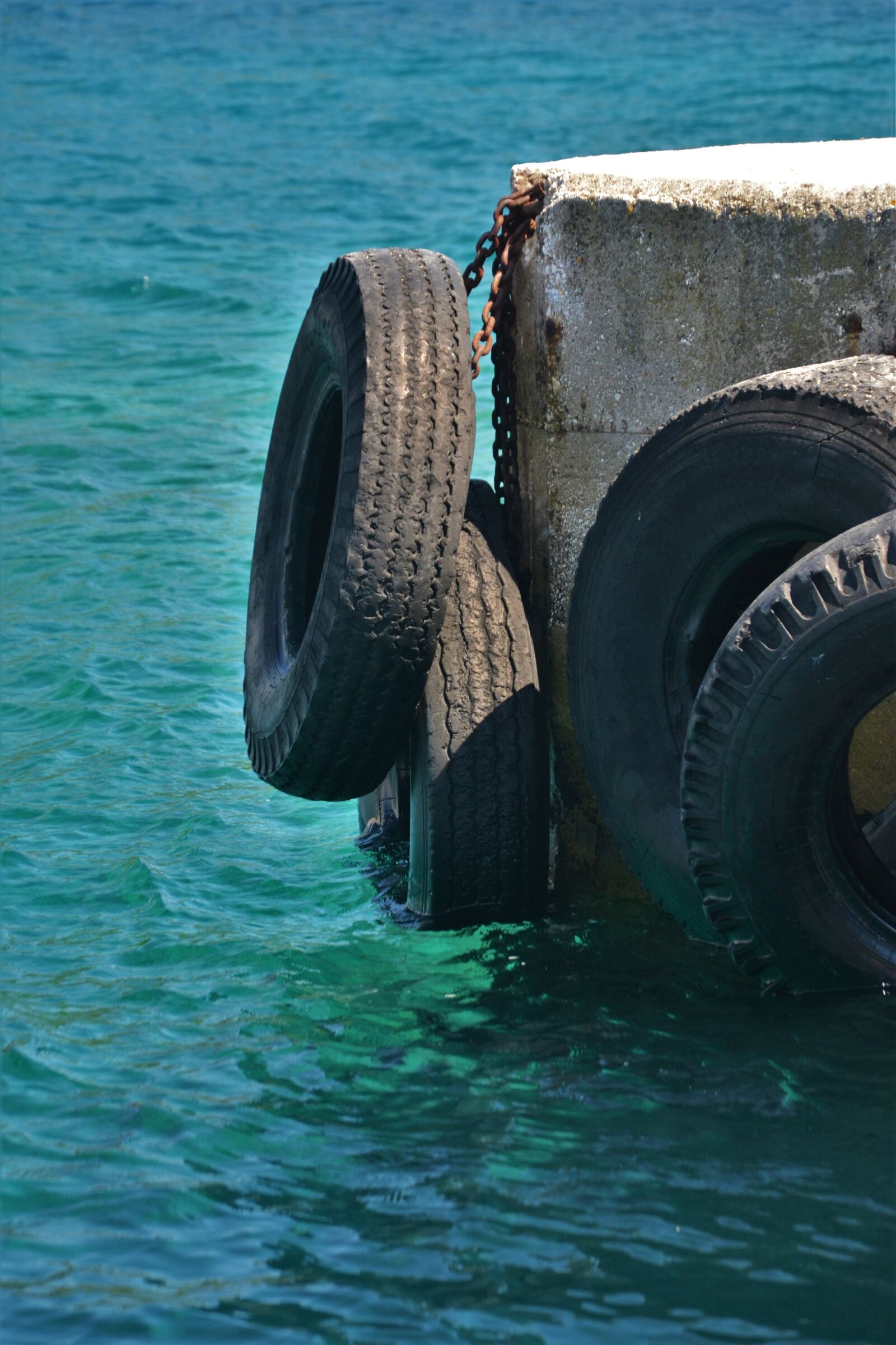 Nikon D3100 sample photo. Pier, auto tires, buffer photography