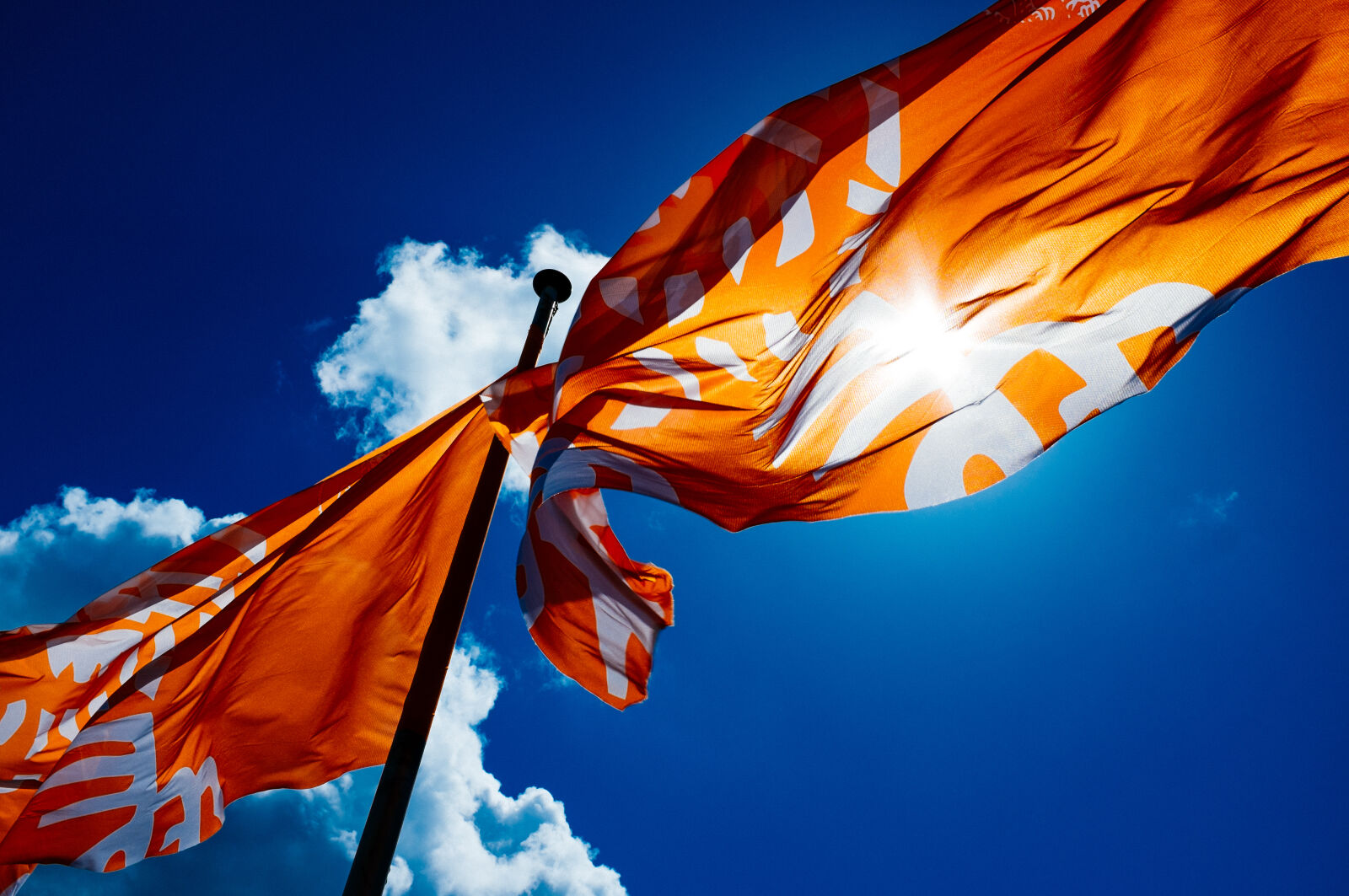 Fujifilm X100S sample photo. Blue, sky, clouds, flags photography