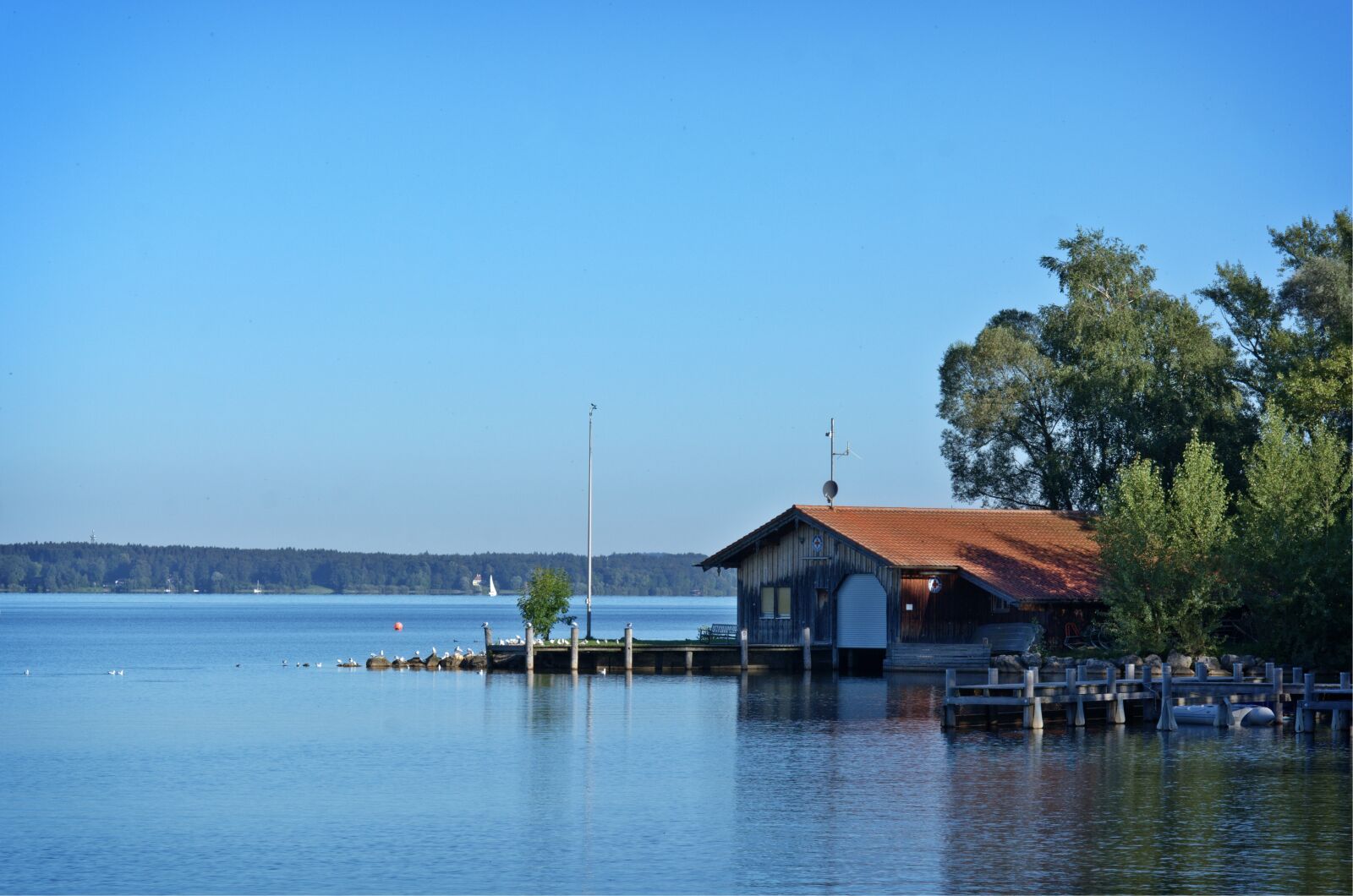 55.0-200.0mm f/4.0-f/5.6 sample photo. Log cabin, boat house photography