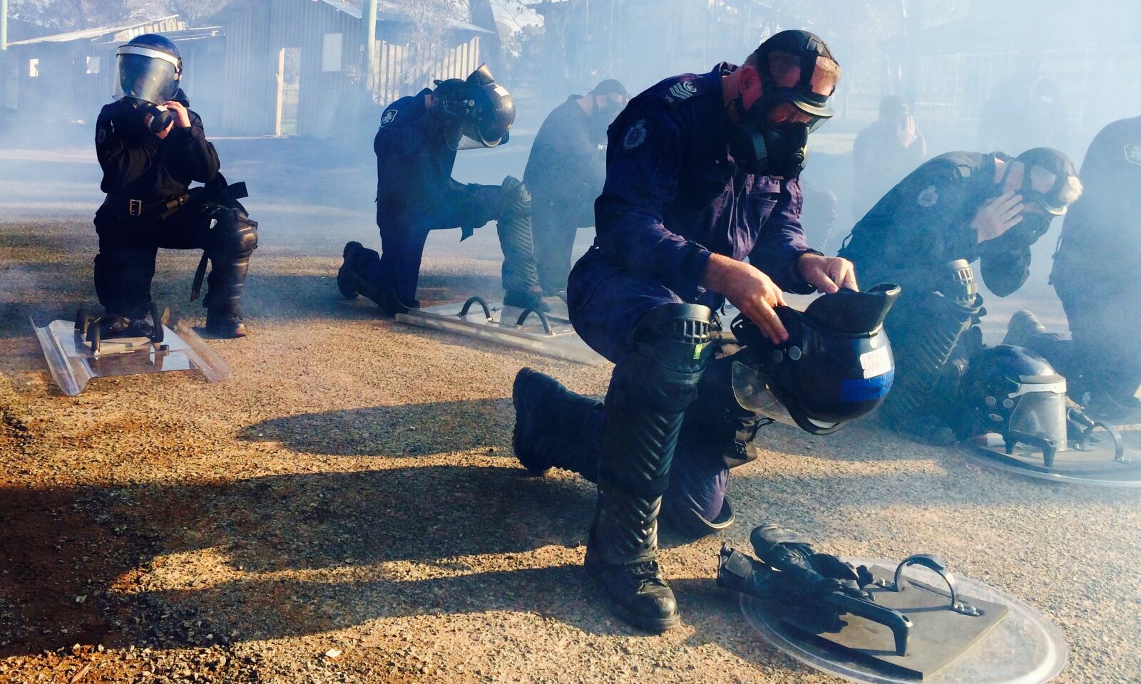 iPhone 5s back camera 4.15mm f/2.2 sample photo. Police, gas mask, riot photography
