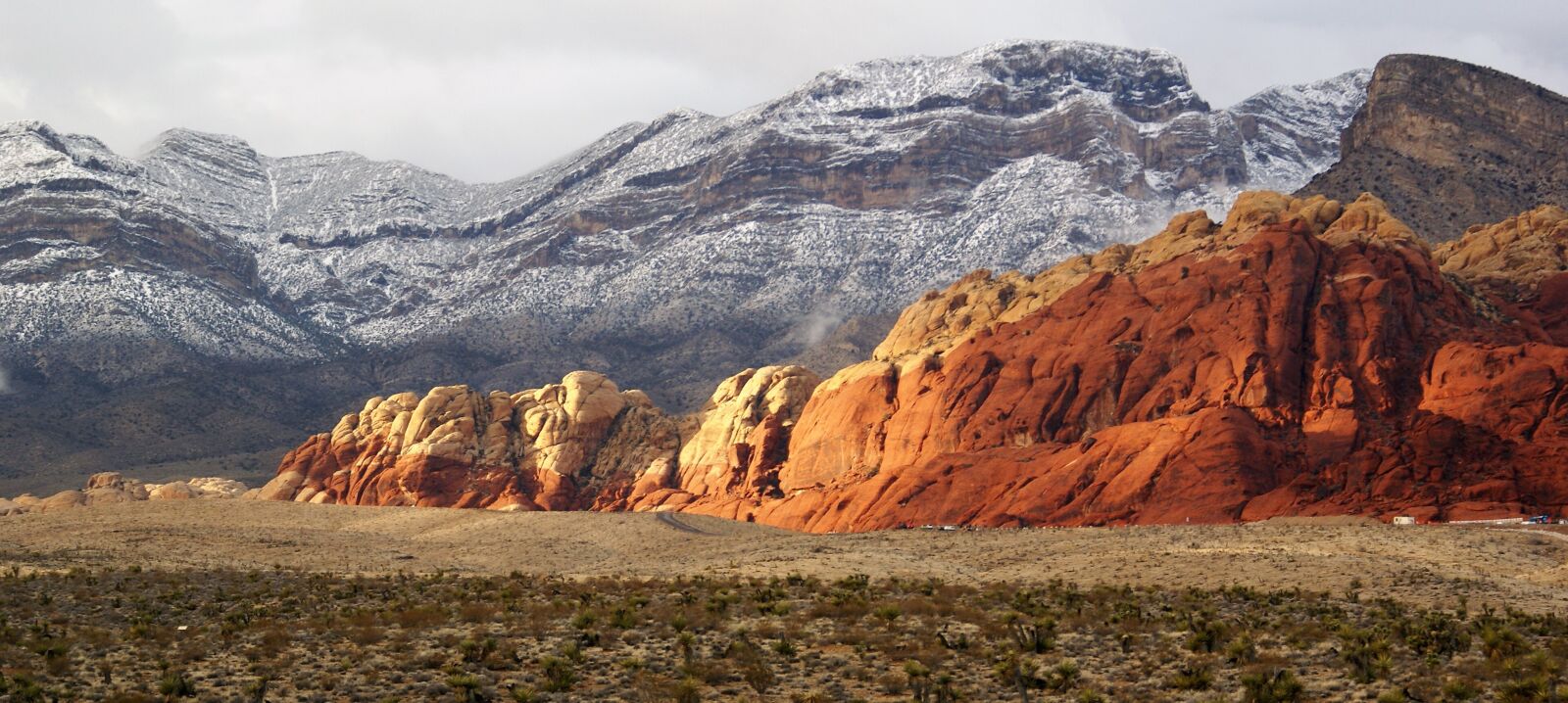 Sony Alpha DSLR-A100 sample photo. Red rock, snow, mountains photography