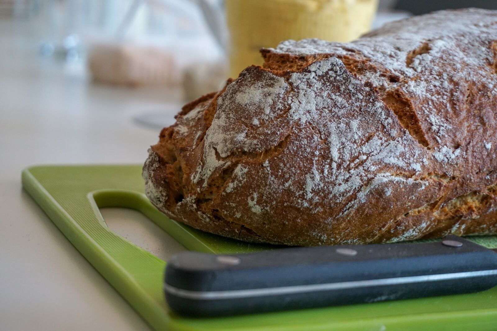 Sony E 16-50mm F3.5-5.6 PZ OSS sample photo. Bread, bread knife, board photography