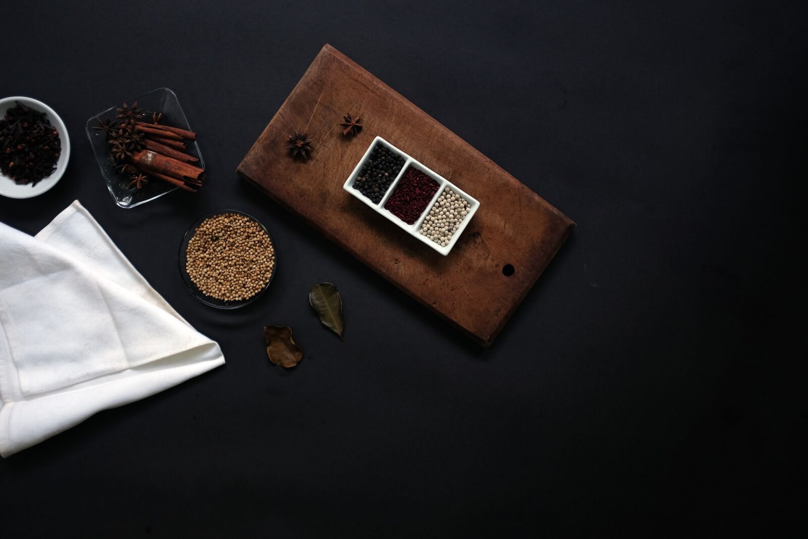 Fujifilm X100T sample photo. Black background, container, spices photography