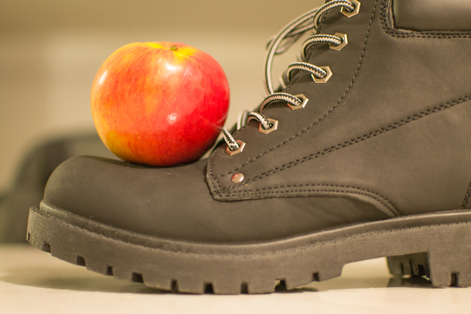 Nikon D3100 + Nikon AF-S DX Nikkor 35mm F1.8G sample photo. Apple, fruit, shoe photography