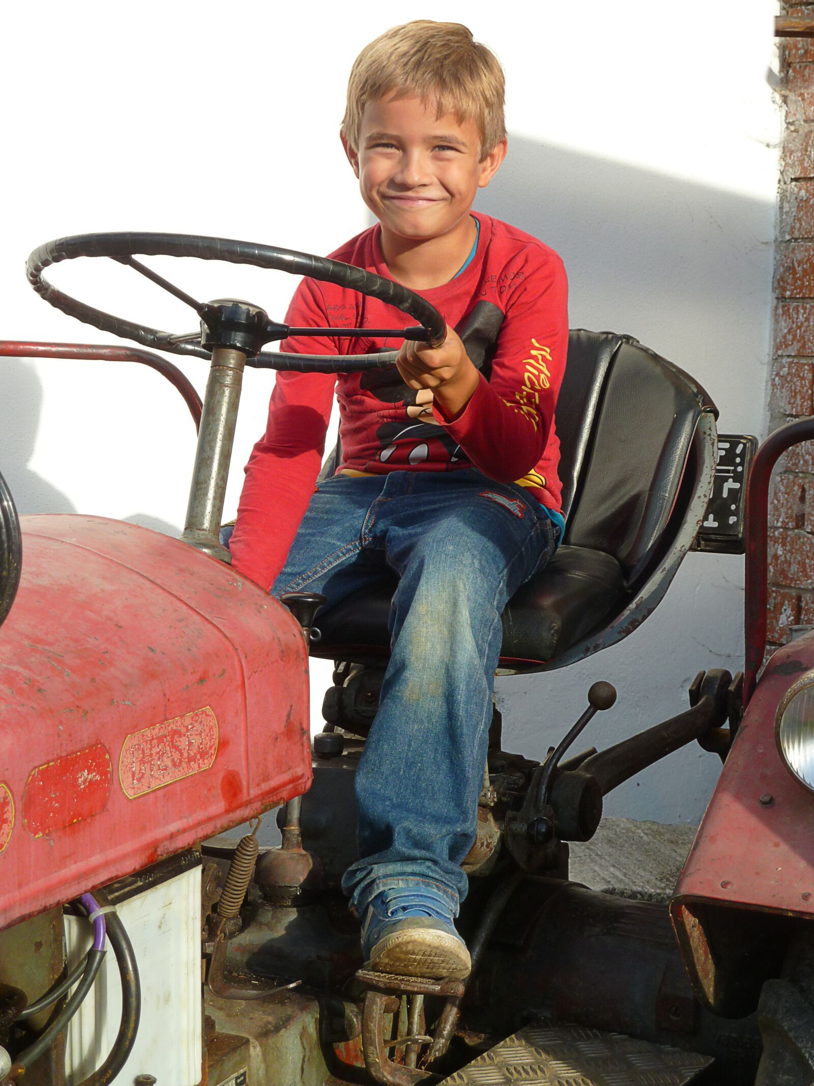 Panasonic Lumix DMC-ZS7 (Lumix DMC-TZ10) sample photo. Boy, tractor, red photography