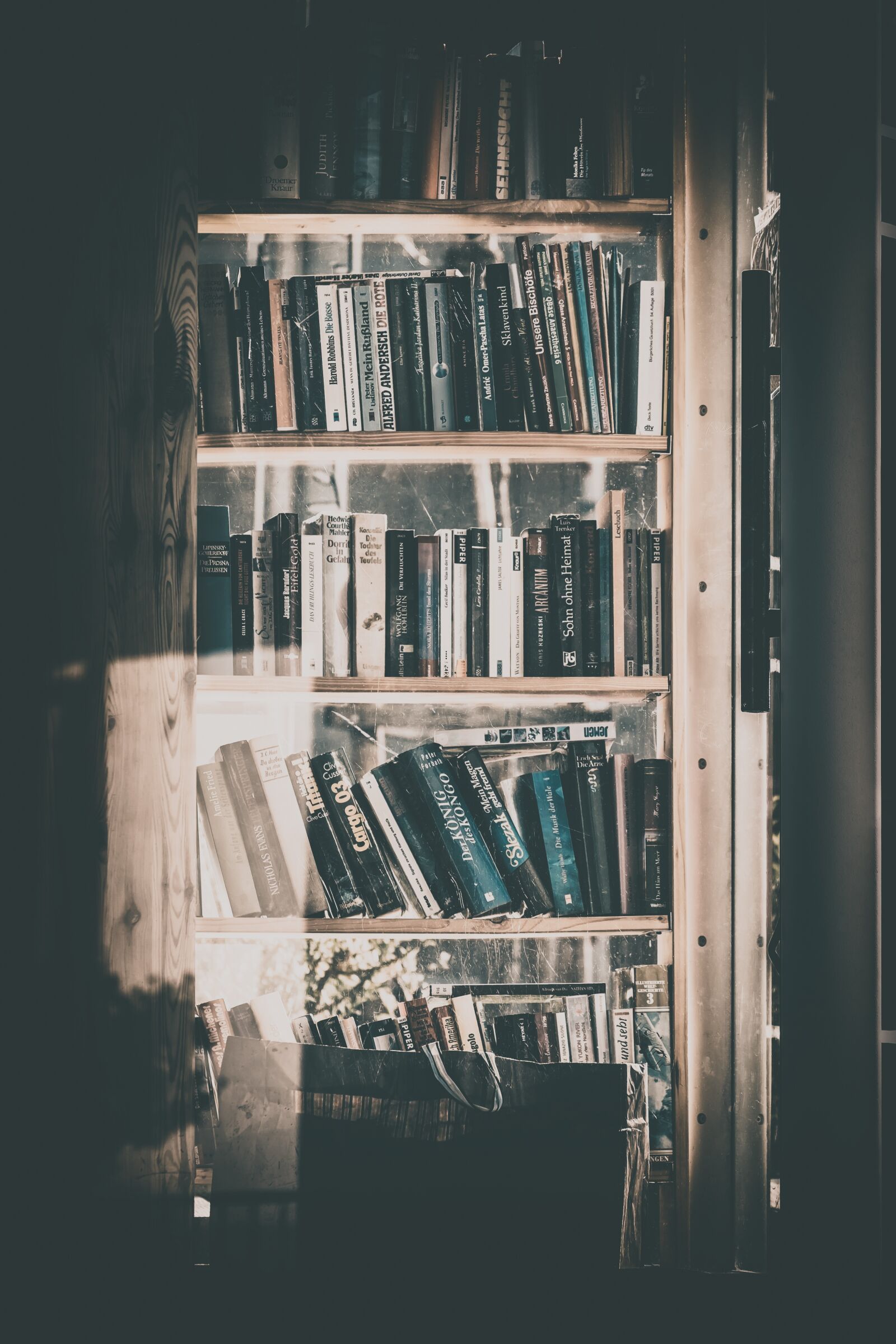 Fujifilm XF 55-200mm F3.5-4.8 R LM OIS sample photo. Books, bookshelf, phone booth photography