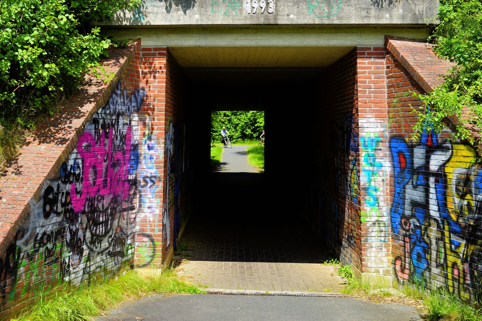Sony Planar T* 50mm F1.4 ZA SSM sample photo. Tunnel, underpass, cyclists photography