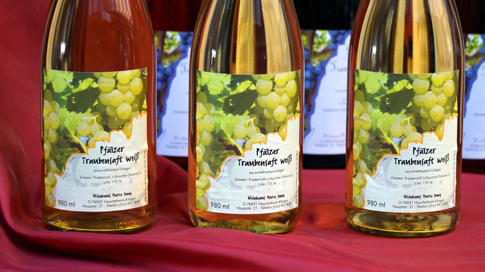 Sony Alpha a5000 (ILCE 5000) + Sony E 55-210mm F4.5-6.3 OSS sample photo. Grape juice, drink, bottles photography