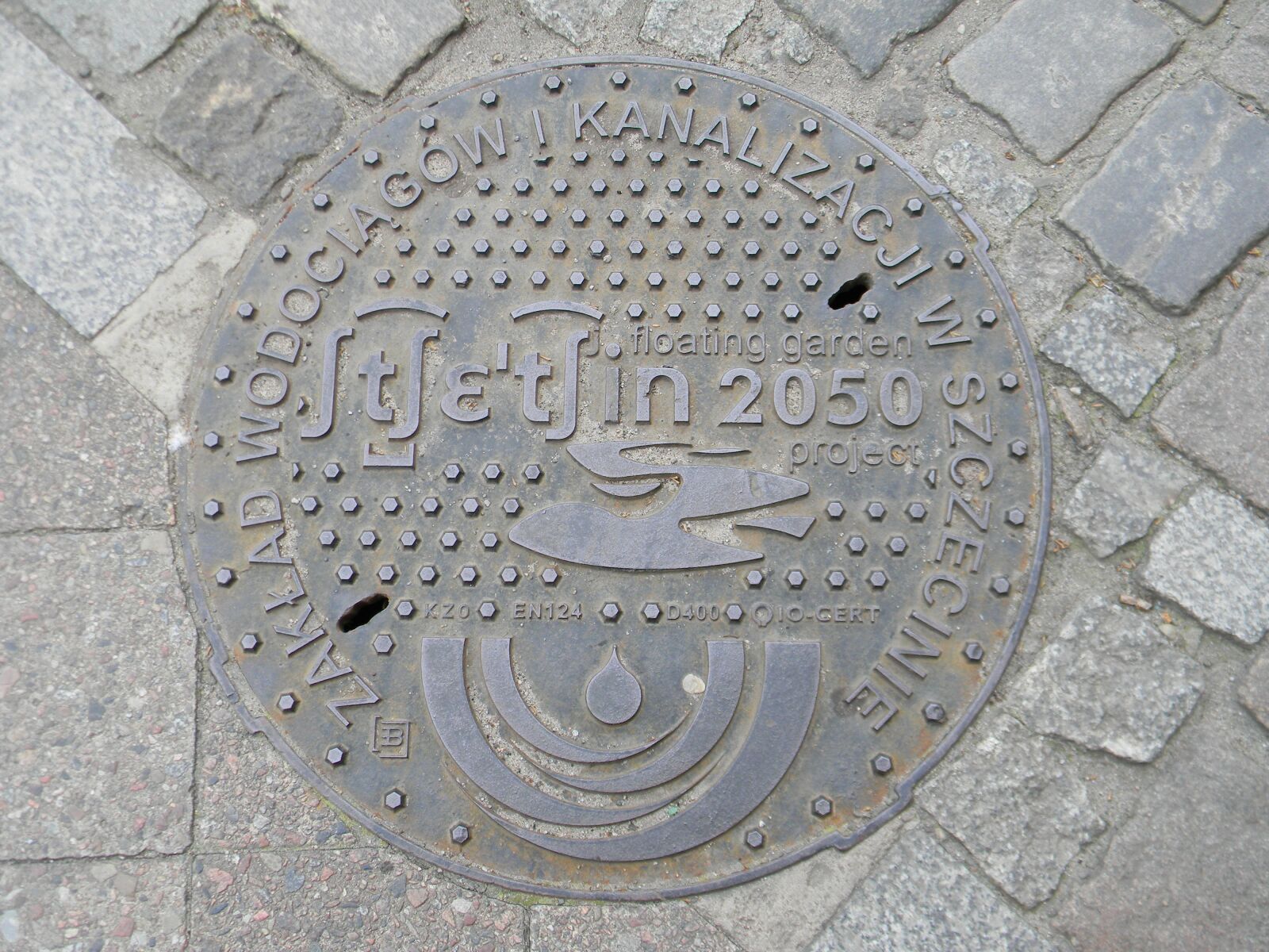 Nikon Coolpix L110 sample photo. Manhole, cover, street photography
