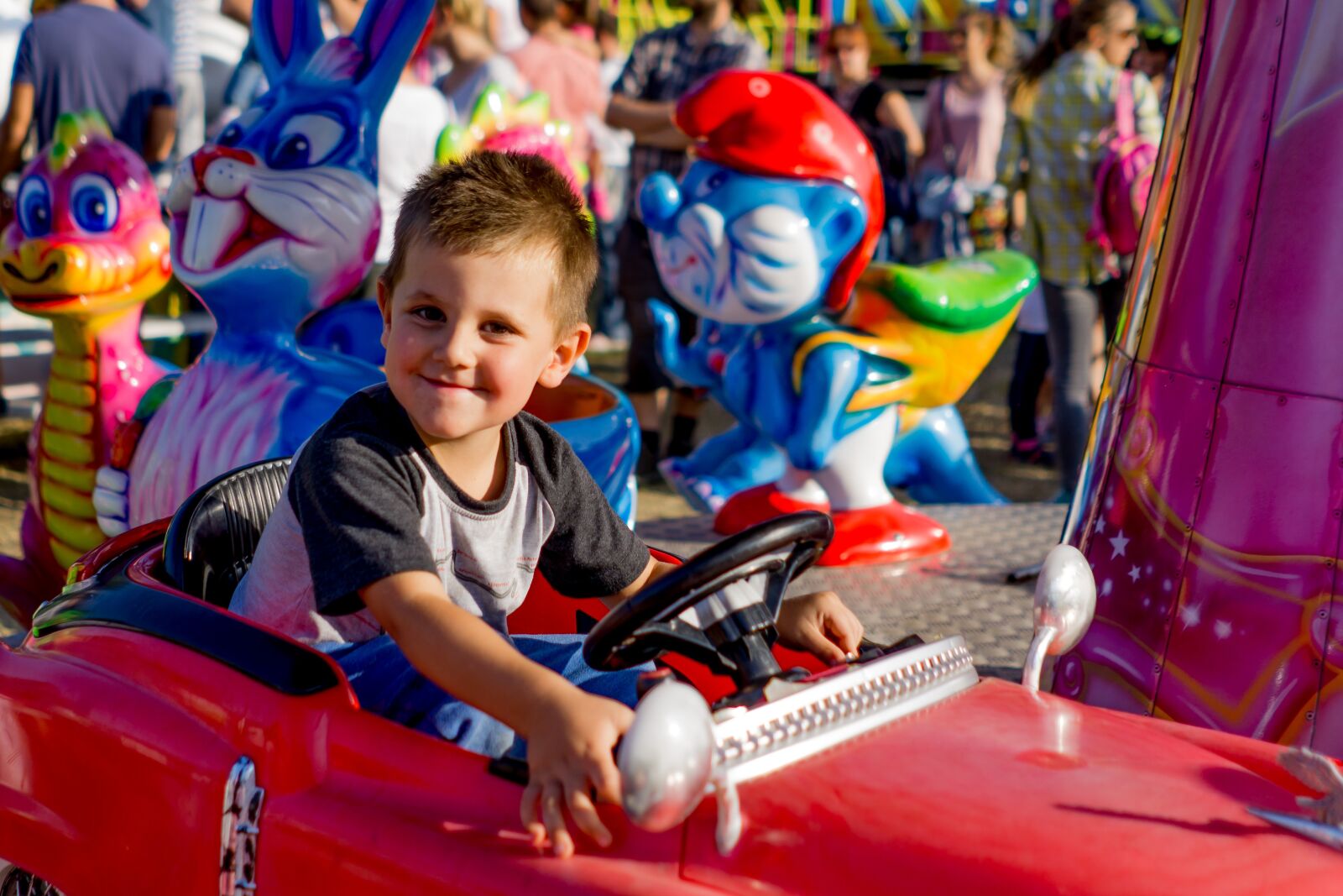 Sony FE 28mm F2 sample photo. Boy, pleasure, carousel photography