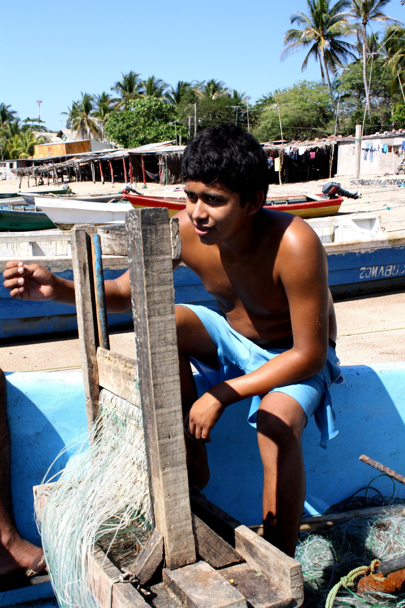 Canon EOS 1000D (EOS Digital Rebel XS / EOS Kiss F) sample photo. Young boy, fishing boat photography